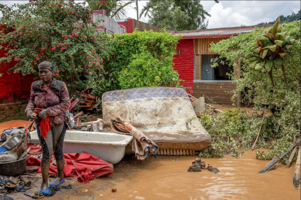 A resident salvages her household items washed away in the Rubavu district in Rwanda.(Reuters: Jean Bizimana)